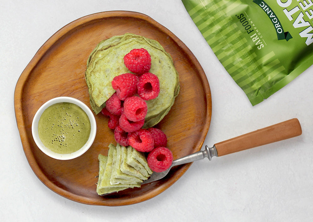 Superfood Matcha pancakes on a plate with raspberries.