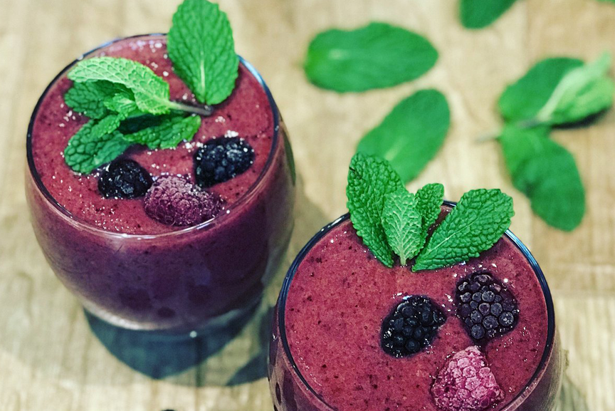 Two superfood berry cocktails in glasses.
