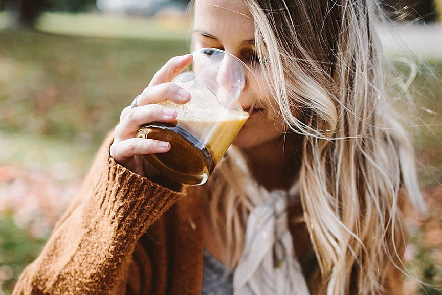 Woman drinking golden turmeric tea