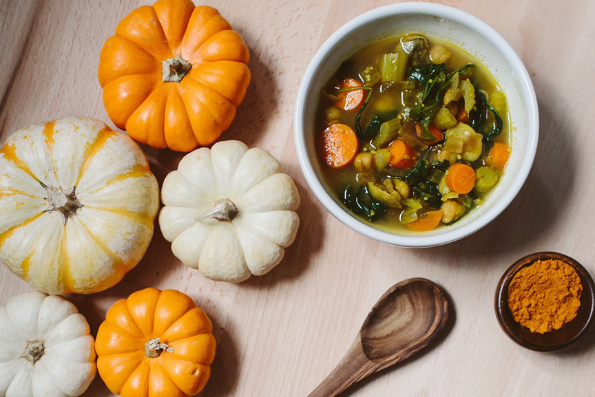 Warming turmeric soup in a bowl by pumpkin display