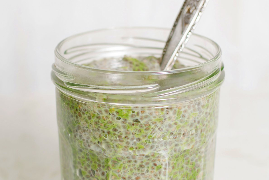 Wheatgrass chia pudding in a jar with spoon.